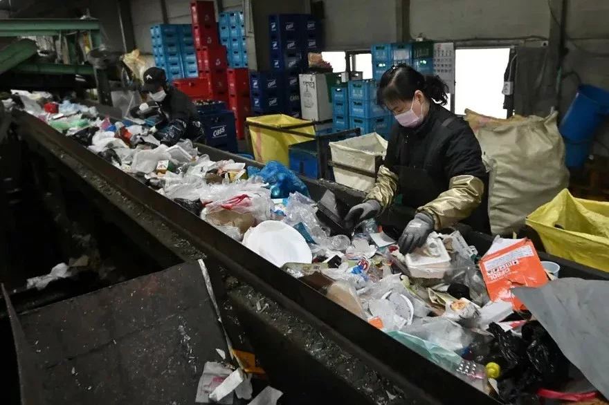 Workers sort rubbish